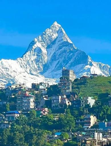 A Himalayan mountain rising above a settlement in Nepal